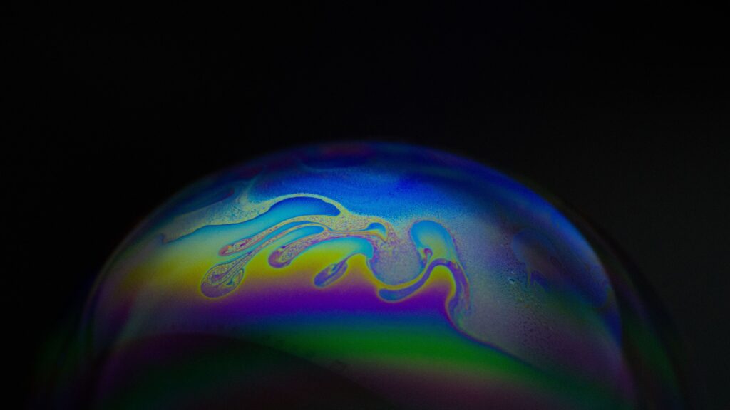 Close-up of a vibrant and colorful soap bubble surface with flowing liquid patterns.
